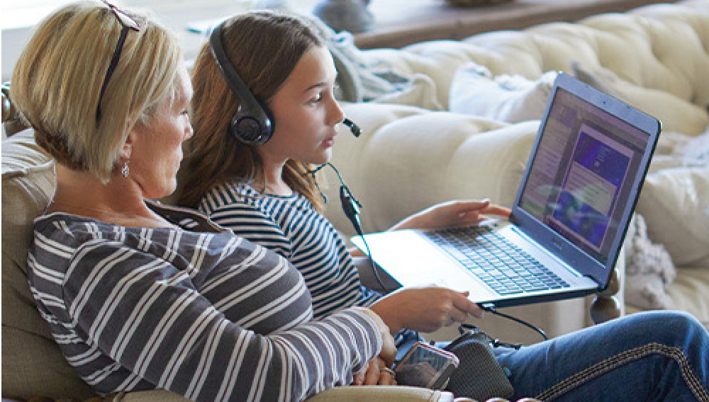Mother and daughter attending to an online class at home