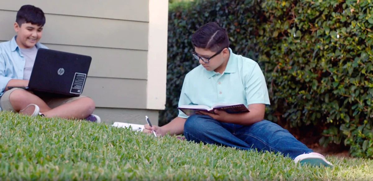 Student doing homework on his yard
